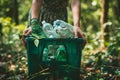 Woman holding a garbage box with plastic bottles