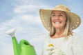 Woman Holding Gardening Equipment Against Sky