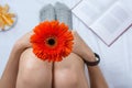 Woman holding a gerbera flower in bed Royalty Free Stock Photo