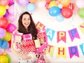 Woman holding gift box at birthday party. Royalty Free Stock Photo