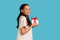 Woman holding gift box, congratulating, extremely happy to get present, looking at camera. Royalty Free Stock Photo