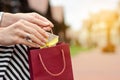 A woman is holding a gift package bag in hand shopping jewerly box ring