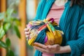 woman holding a gift wrapped in colorful cloth using furoshiki technique