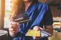 A woman holding and giving credit card to someone Royalty Free Stock Photo