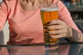 Woman holding a glass of beer