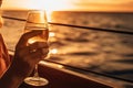 Woman Holding Glass Of Champagne, On Catamaran Sailing The Ocean At Sunset. Generative AI