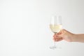 Woman holding glass of expensive white wine