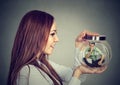 Woman holding a glass jar with imprisoned man in it Royalty Free Stock Photo