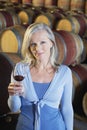 Woman Holding Glass Of Red Wine In Cellar Royalty Free Stock Photo
