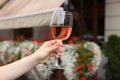 Woman holding glass of rose wine outdoors, closeup Royalty Free Stock Photo