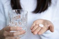 Woman holding a glass of water with a tablet Royalty Free Stock Photo