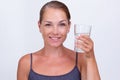 Woman holding glass of water on white background