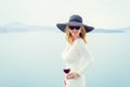 Woman holding glass of wine. Retro, vintage style filter. Royalty Free Stock Photo