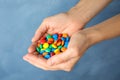 Woman holding glazed candies on color background Royalty Free Stock Photo