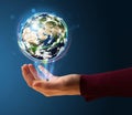 Woman holding a glowing earth globe Royalty Free Stock Photo