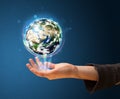 Woman holding a glowing earth globe Royalty Free Stock Photo