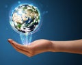 Woman holding a glowing earth globe Royalty Free Stock Photo