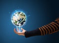 Woman holding a glowing earth globe Royalty Free Stock Photo