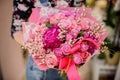 Woman holding a gorgeous flower bouquet in pink tones for Valentines day