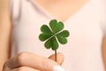 Woman holding green four leaf clover in hand, closeup Royalty Free Stock Photo