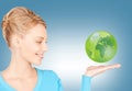 Woman holding green globe on her hand Royalty Free Stock Photo