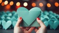 Woman holding a green heart in front of many paper hearts, AI Royalty Free Stock Photo