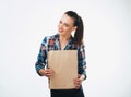 Woman is holding grocery shopping bag on white background. Paper bags in hands. Isolated background. Royalty Free Stock Photo