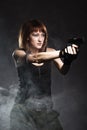 Woman holding gun with smoke Royalty Free Stock Photo