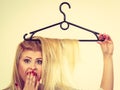 Woman holding hair on clothes hanger