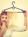 Woman holding hair on clothes hanger