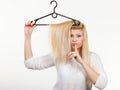 Woman holding hair on clothes hanger