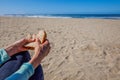 woman holding half eaten sandwhich at the beach Royalty Free Stock Photo