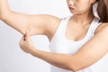 Woman holding a hand with excess fat for checking her upper arm so unhappy with flabby skin Royalty Free Stock Photo