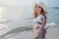 Woman holding hand of her boyfriend while leading to sea beach