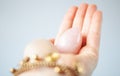 woman holding in hand a vaginal & x28;yoni& x29; egg. Rose quartz crystal jade egg. Copy space Royalty Free Stock Photo