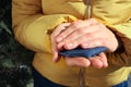 Woman holding hand warmer outdoors, closeup view