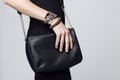 Woman holding handbag, focus on the handbag Royalty Free Stock Photo