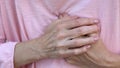 Woman holding hands on chest, sudden heart attack, health problem, emergency