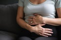 woman holding hands on her belly, stabbing pain in abdomen diarrhea generative ai