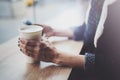 Woman holding hands smartphone and texting message.Female hands using mobile phone.Closeup on blurred background.Flares Royalty Free Stock Photo