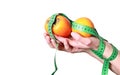Woman holding healthy exotic fruits and a tape measure ready for dieting
