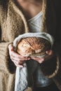 Woman holding healthy wheat Swedish bread round loaf in hands Royalty Free Stock Photo