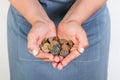 Woman holding a a heap of coin with both hands