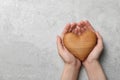 Woman holding heart on grey stone background, top view with space for text. Donation Royalty Free Stock Photo