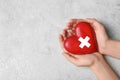 Woman holding heart on grey stone background, top view with space for text. Donation Royalty Free Stock Photo