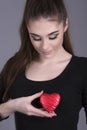 Woman holding a heart shape against her body Royalty Free Stock Photo