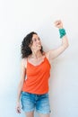 A woman is holding her arm up in the air with a scarf in her wrist as a symbol of the struggle for the legalization of abortion in