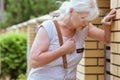 Woman is holding her chest while standing on the street, heart attack concept Royalty Free Stock Photo