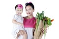 Woman holding her child and vegetables Royalty Free Stock Photo