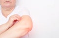 Woman holding her elbow joint, inflammation and pain in the elbow joint, tendens and bursitis, white background, copy space Royalty Free Stock Photo